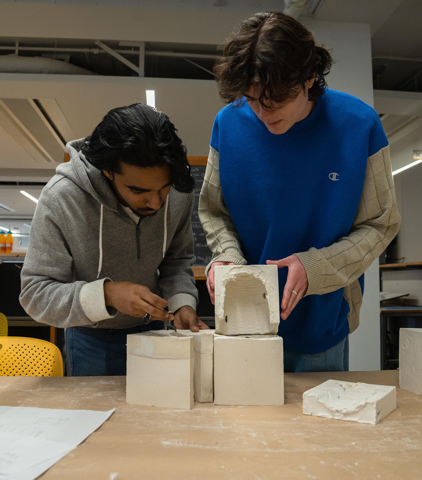 Male architecture students building a model