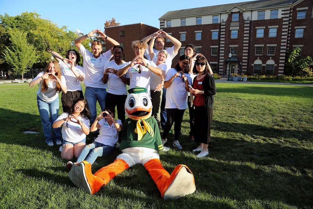 Group of international students posing with the Oregon Duck mascot