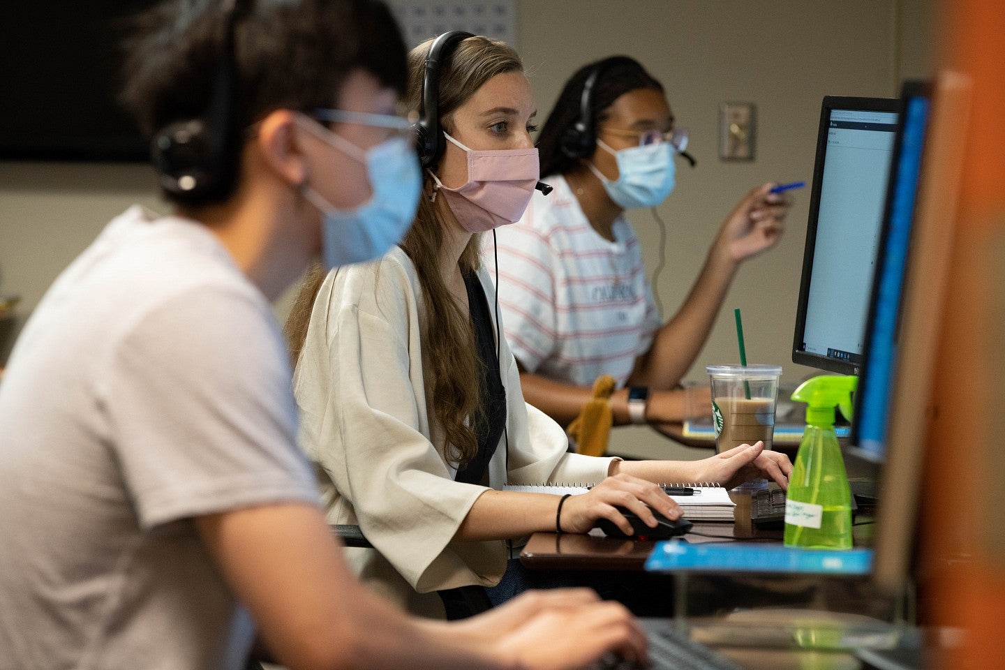 students working in the corona corp wearing masks
