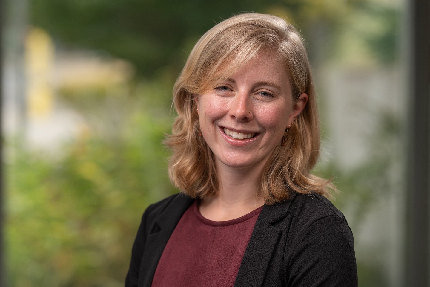 Headshot of Meaghan Bogart standing in greenery