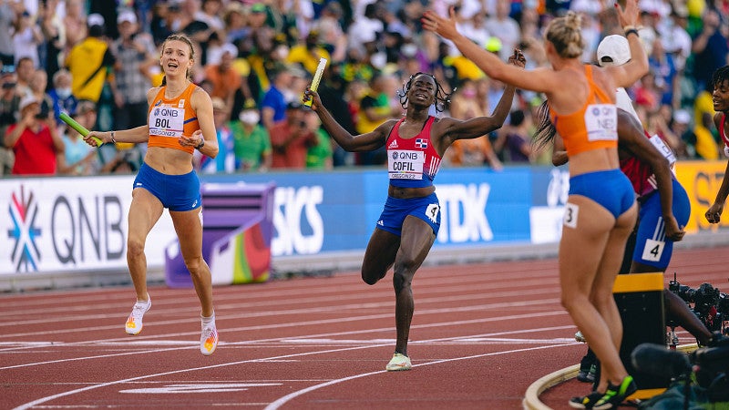 Two track athletes crossing the finish line during a race