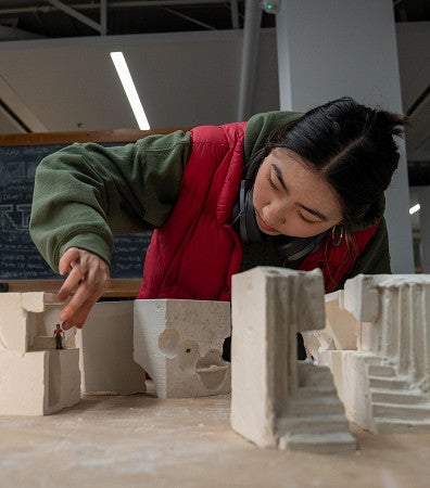 architecture student working on a model