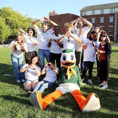 Group of international students posing with the Oregon Duck mascot