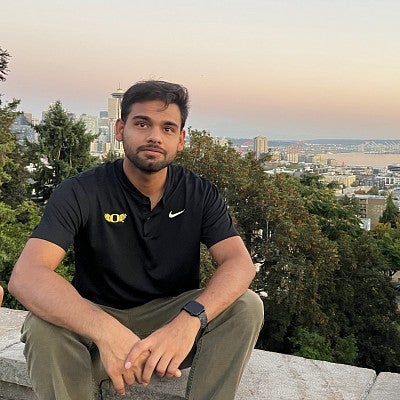 Kart Sharma Headshot in front of Seattle skyline