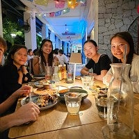 UO student eating a meal with friends in Singapore