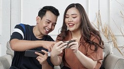 two students gaming on cell phones